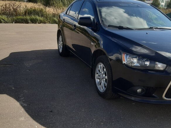 2012 Mitsubishi Lancer X Рестайлинг, чёрный, 1050000 рублей - вид 2