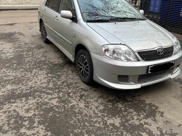 2004 Toyota Corolla IX (E120, E130), серебристый - вид 2