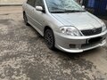 2004 Toyota Corolla IX (E120, E130), серебристый - вид 2