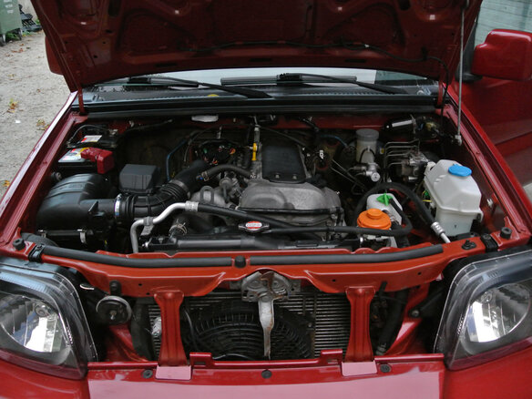 2011 Suzuki Jimny III Рестайлинг 1, красный
