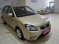 2010 Kia Rio II Рестайлинг, бежевый - вид 1