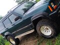 1998 Jeep Cherokee II (XJ) Рестайлинг, зелёный - вид 7